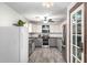 Updated kitchen features gray cabinets, butcher block countertops, stainless steel appliances, and wood-look flooring at 28213 N Holly Rd, San Tan Valley, AZ 85143