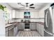Kitchen with stainless steel appliances, butcher block countertops, gray cabinets, and a stainless steel farm sink at 28213 N Holly Rd, San Tan Valley, AZ 85143
