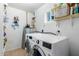 Efficient laundry room with modern washer and dryer, built-in shelving at 28213 N Holly Rd, San Tan Valley, AZ 85143