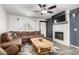 Cozy living room featuring a fireplace, wood floors, and a comfortable sectional sofa at 28213 N Holly Rd, San Tan Valley, AZ 85143