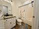 Cozy bathroom with floral shower curtain, granite counters, and a well-lit mirror at 3547 W Whispering Wind Dr, Glendale, AZ 85310