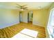 Bright bedroom featuring hardwood floors, ceiling fan, ensuite bath and a large window at 37567 W Roosevelt St, Tonopah, AZ 85354