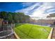 Spacious backyard with a pool, artificial turf, trampoline, and playhouse at 3841 E Oxford Ln, Gilbert, AZ 85295
