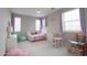 This bedroom has a rainbow wall decoration, a play market and a table with chairs at 3841 E Oxford Ln, Gilbert, AZ 85295