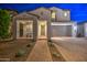 Charming two-story home with a well-manicured front yard and a welcoming entrance at night at 3841 E Oxford Ln, Gilbert, AZ 85295