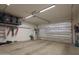A well-lit garage featuring an insulated door and organized storage solutions, ideal for projects at 3841 E Oxford Ln, Gilbert, AZ 85295