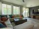 Inviting living room with a plush sectional, dark accent wall, and sliding glass doors at 3841 E Oxford Ln, Gilbert, AZ 85295