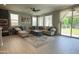 Spacious living room featuring a comfortable sectional sofa and sliding glass door to the backyard at 3841 E Oxford Ln, Gilbert, AZ 85295