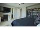 This main bedroom has a TV, carpet, bookcase, desk and an ensuite bathroom at 3841 E Oxford Ln, Gilbert, AZ 85295