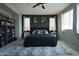 This main bedroom has a ceiling fan, carpet and two windows with blinds and curtains at 3841 E Oxford Ln, Gilbert, AZ 85295