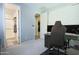 Office with modern furnishings, desk, and adjacent bathroom and hallway at 3841 E Oxford Ln, Gilbert, AZ 85295