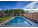 Inviting swimming pool surrounded by sleek concrete and enclosed with safety fencing at 3841 E Oxford Ln, Gilbert, AZ 85295