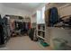 This walk-in closet has built-in shelves and hanging rods for organization at 3841 E Oxford Ln, Gilbert, AZ 85295