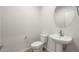 Charming half-bathroom with tile floors, neutral walls, and a pedestal sink with stylish faucet at 42855 W Palo Abeto Dr, Maricopa, AZ 85138