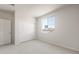 Bright bedroom features neutral carpeting, closet, and a large window offering plenty of natural light at 42855 W Palo Abeto Dr, Maricopa, AZ 85138