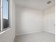 Comfortable bedroom features neutral carpeting, closet, and a large window offering plenty of natural light at 42855 W Palo Abeto Dr, Maricopa, AZ 85138