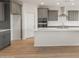 Bright kitchen featuring gray cabinetry, a large island, and stainless steel appliances at 42855 W Palo Abeto Dr, Maricopa, AZ 85138