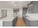 Modern kitchen featuring gray cabinets, stainless steel appliances, and a large island at 42855 W Palo Abeto Dr, Maricopa, AZ 85138