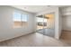 Bright living room with sliding glass door to covered patio and desert landscaping at 42855 W Palo Abeto Dr, Maricopa, AZ 85138