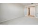 Spacious living room with neutral carpeting and double doors that open to another room at 42855 W Palo Abeto Dr, Maricopa, AZ 85138