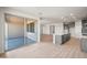 Open living space with sliding glass doors, gray cabinets, tile floors, and recessed lighting at 42855 W Palo Abeto Dr, Maricopa, AZ 85138
