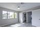 Bedroom featuring a neutral wall, wood-look floor, window and view to a bathroom at 4901 S Calle Los Cerros Dr # 206, Tempe, AZ 85282