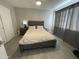 Cozy bedroom featuring a wood frame bed, neutral walls, and wood-look floors at 4901 S Calle Los Cerros Dr # 206, Tempe, AZ 85282