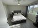 A charming bedroom features a wooden-framed bed, natural light and an airy feel at 4901 S Calle Los Cerros Dr # 206, Tempe, AZ 85282
