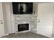 Cozy fireplace with stacked stone surround and wall-mounted TV at 4901 S Calle Los Cerros Dr # 206, Tempe, AZ 85282