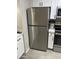 Stainless steel refrigerator compliments the white cabinets and countertop in this modern kitchen at 4901 S Calle Los Cerros Dr # 206, Tempe, AZ 85282