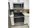 The updated kitchen features stainless steel appliances and white cabinets at 4901 S Calle Los Cerros Dr # 206, Tempe, AZ 85282