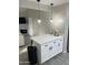 Well-appointed kitchenette with an island, pendant lighting, and black hardware at 4901 S Calle Los Cerros Dr # 206, Tempe, AZ 85282