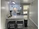 Charming kitchenette with white cabinets, quartz countertop, and barstool seating at 4901 S Calle Los Cerros Dr # 206, Tempe, AZ 85282