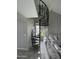 Modern living room featuring a decorative spiral staircase and neutral tones at 4901 S Calle Los Cerros Dr # 206, Tempe, AZ 85282