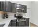 Kitchen features white countertops, subway tile backsplash, stainless steel appliances, and dark cabinetry at 533 E Kyle Ct, Gilbert, AZ 85296