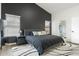 Main bedroom features a gray bedframe, dark accent wall, and views of attached bathroom with glass shower at 533 E Kyle Ct, Gilbert, AZ 85296