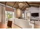 Open living room showcasing beamed ceilings, elegant chandelier, and seamless transition to dining at 6000 E Camelback E Rd # 7707, Scottsdale, AZ 85251