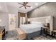 Bedroom featuring a king bed, stylish accent wall, and en-suite bath with soaking tub at 6000 E Camelback E Rd # 7707, Scottsdale, AZ 85251