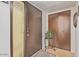 Well-lit foyer with a large front door with decorative window and closet with wooden doors at 6240 N 16Th St # 37, Phoenix, AZ 85016