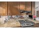 Galley kitchen with granite countertops, stainless steel appliances, and dark wood cabinets at 6240 N 16Th St # 37, Phoenix, AZ 85016