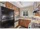 Galley kitchen featuring granite countertops, stainless appliances, and wood cabinets at 6240 N 16Th St # 37, Phoenix, AZ 85016