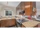Galley kitchen with granite countertops, stainless steel appliances, and dark wood cabinets at 6240 N 16Th St # 37, Phoenix, AZ 85016