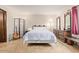 Cozy main bedroom with tiled floors, large mirror, and neutral paint at 6240 N 16Th St # 37, Phoenix, AZ 85016