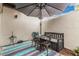 Cozy outdoor patio with bench, table, chairs, and privacy walls at 6240 N 16Th St # 37, Phoenix, AZ 85016