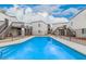 Community pool surrounded by well-maintained buildings and clear blue skies at 6240 N 16Th St # 37, Phoenix, AZ 85016