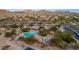 Aerial view of community pool, green spaces, and surrounding homes at 6959 E Red Hawk Cir, Mesa, AZ 85207