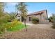 Exterior view of home featuring desert landscape, tiled roof, and covered patio at 6959 E Red Hawk Cir, Mesa, AZ 85207