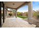 Covered patio with view of the backyard and green space at 6959 E Red Hawk Cir, Mesa, AZ 85207