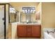 Bathroom showcasing dual sinks, vanity, soaking tub and glass enclosed shower at 6959 E Red Hawk Cir, Mesa, AZ 85207