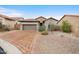 Charming single Gathering home featuring a brick driveway, stone accents, and desert landscaping at 6959 E Red Hawk Cir, Mesa, AZ 85207